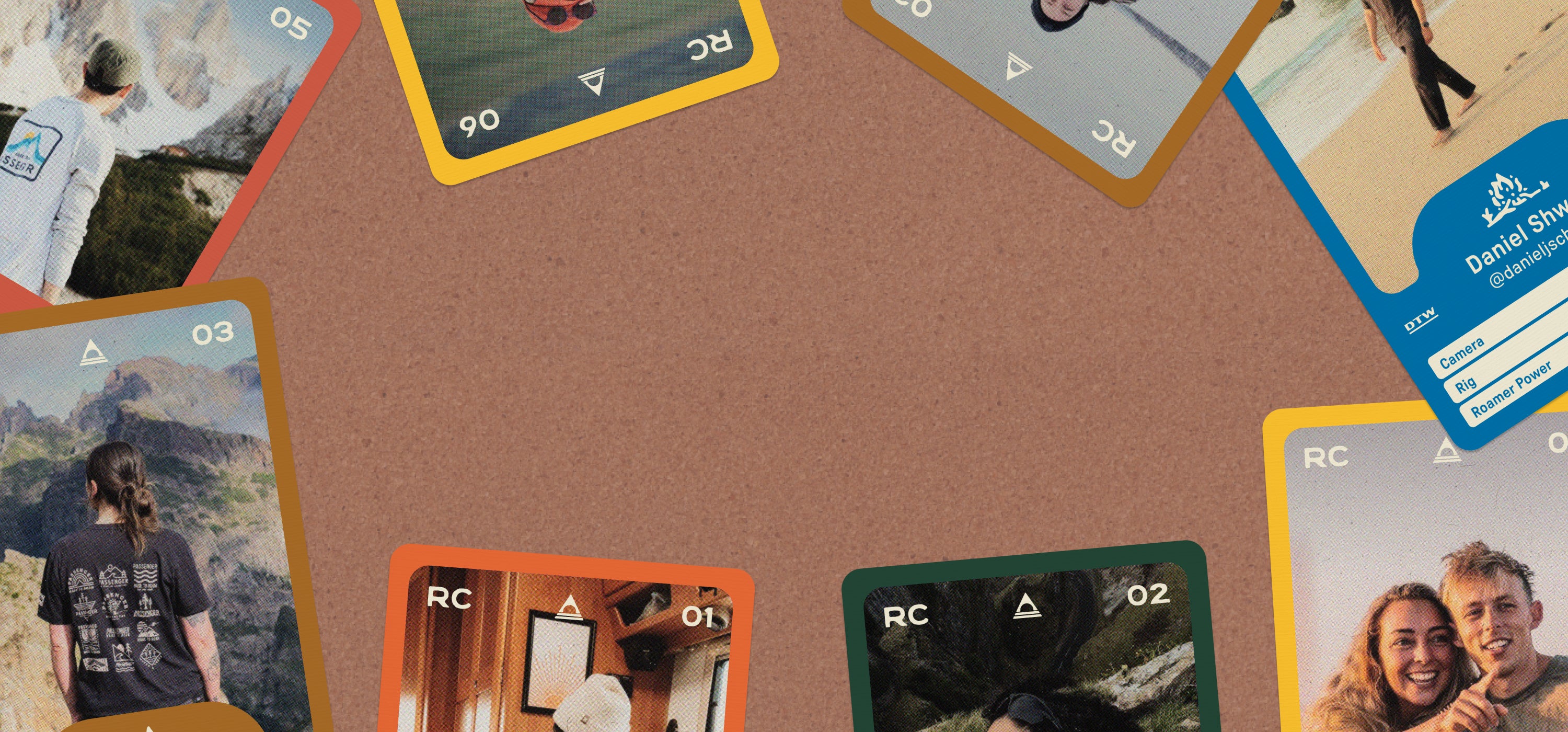 Collection of trading cards on a brown surface with various scenes and people.